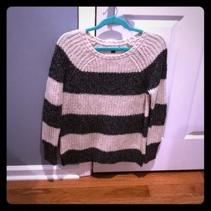 A gray and cream stripped sweater
